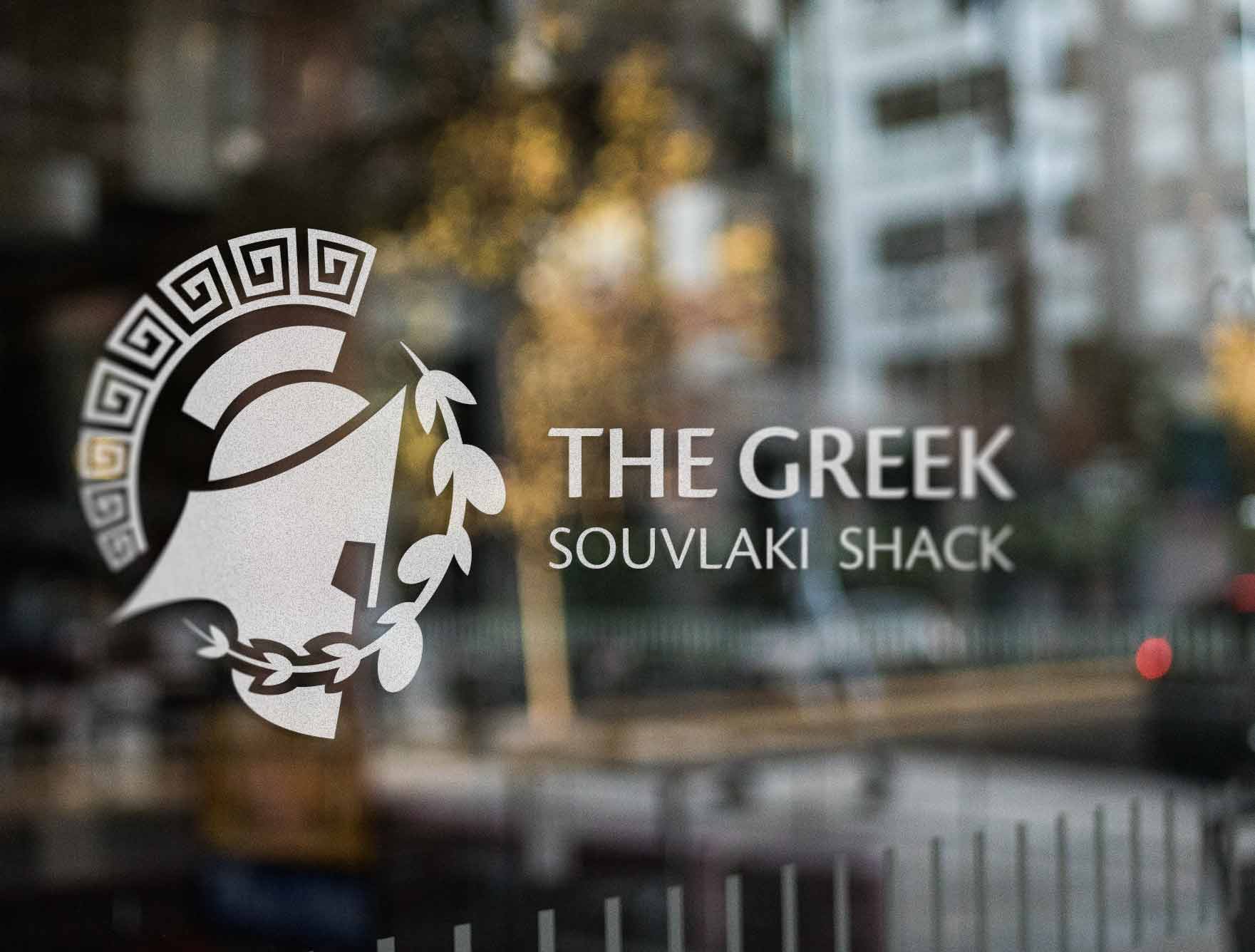 A mockup image of the logo on a glass door storefront.
